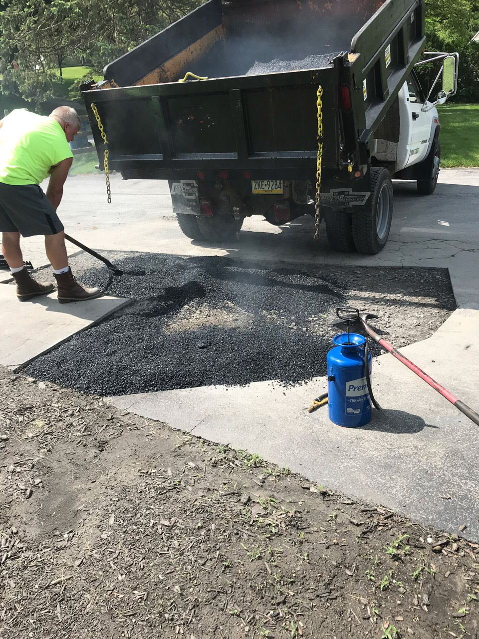 our trucks and team fixing and repairing asphalt driveway